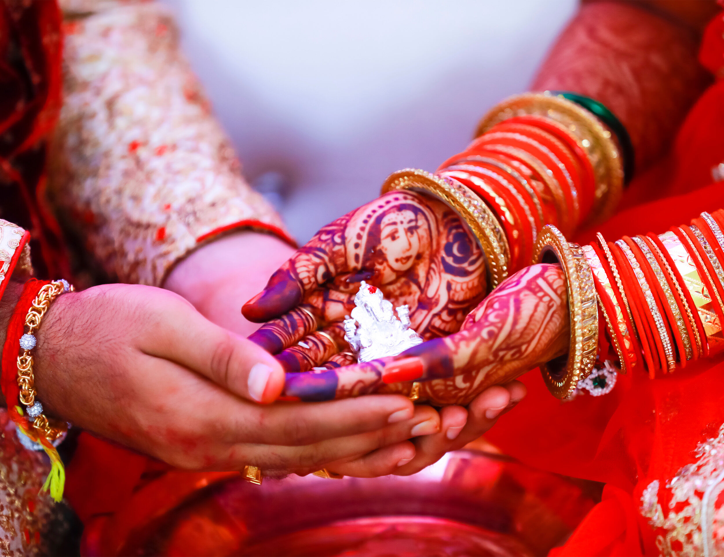A bride and groom exchanging garlands at wedding